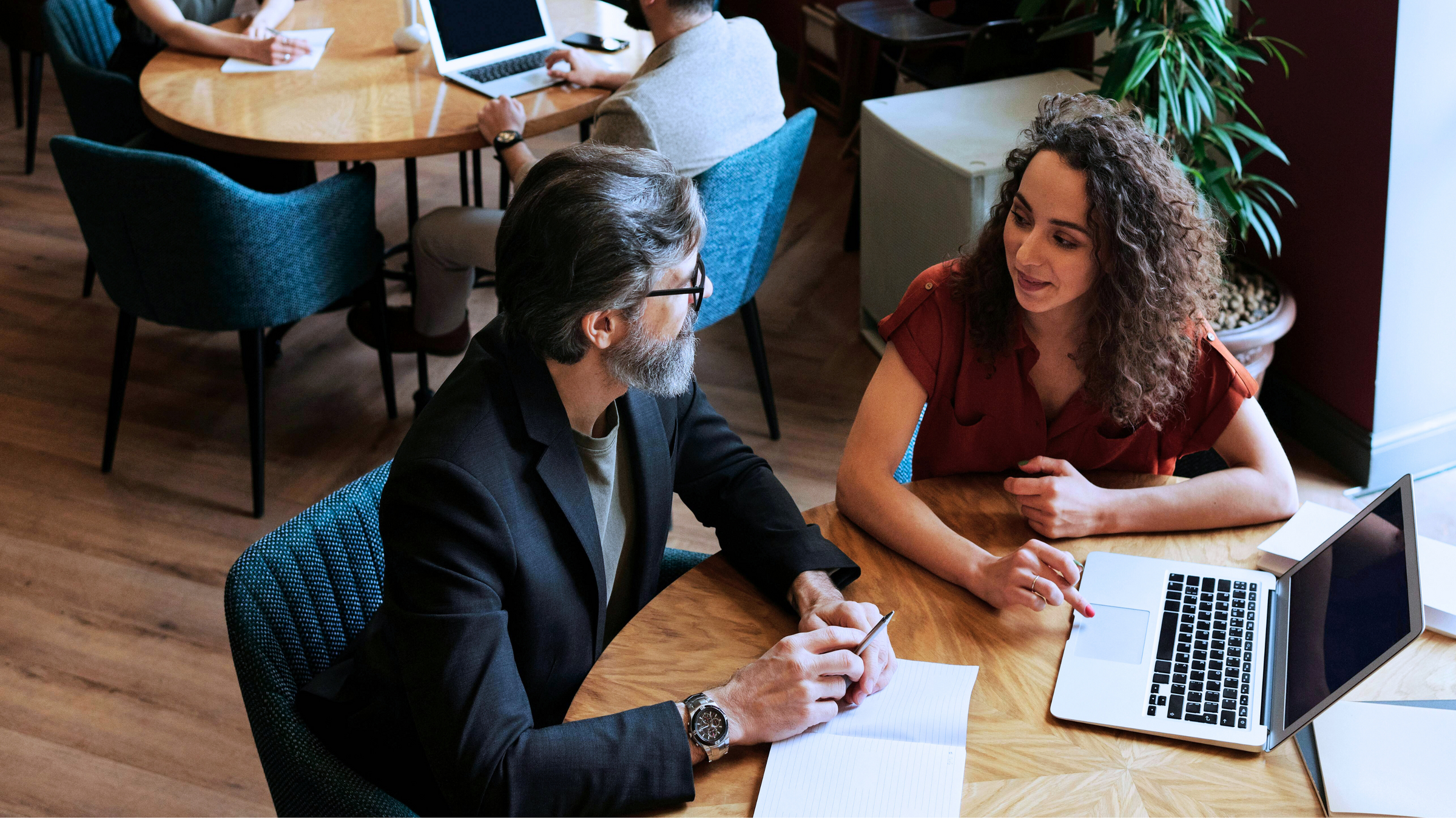A man conducting an executive coaching session with a team member.