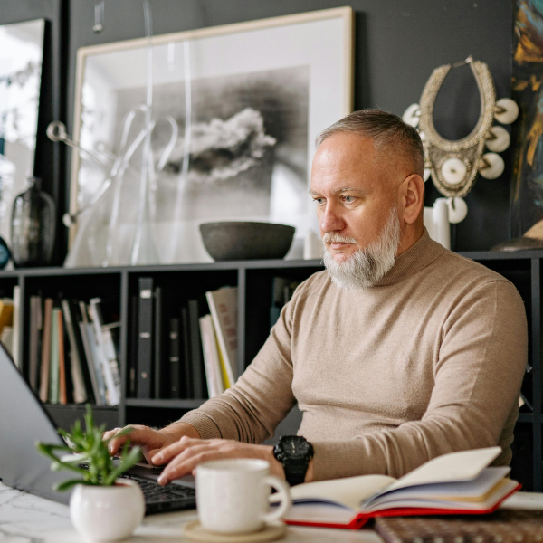 A Chief Executive Officer working at a laptop.