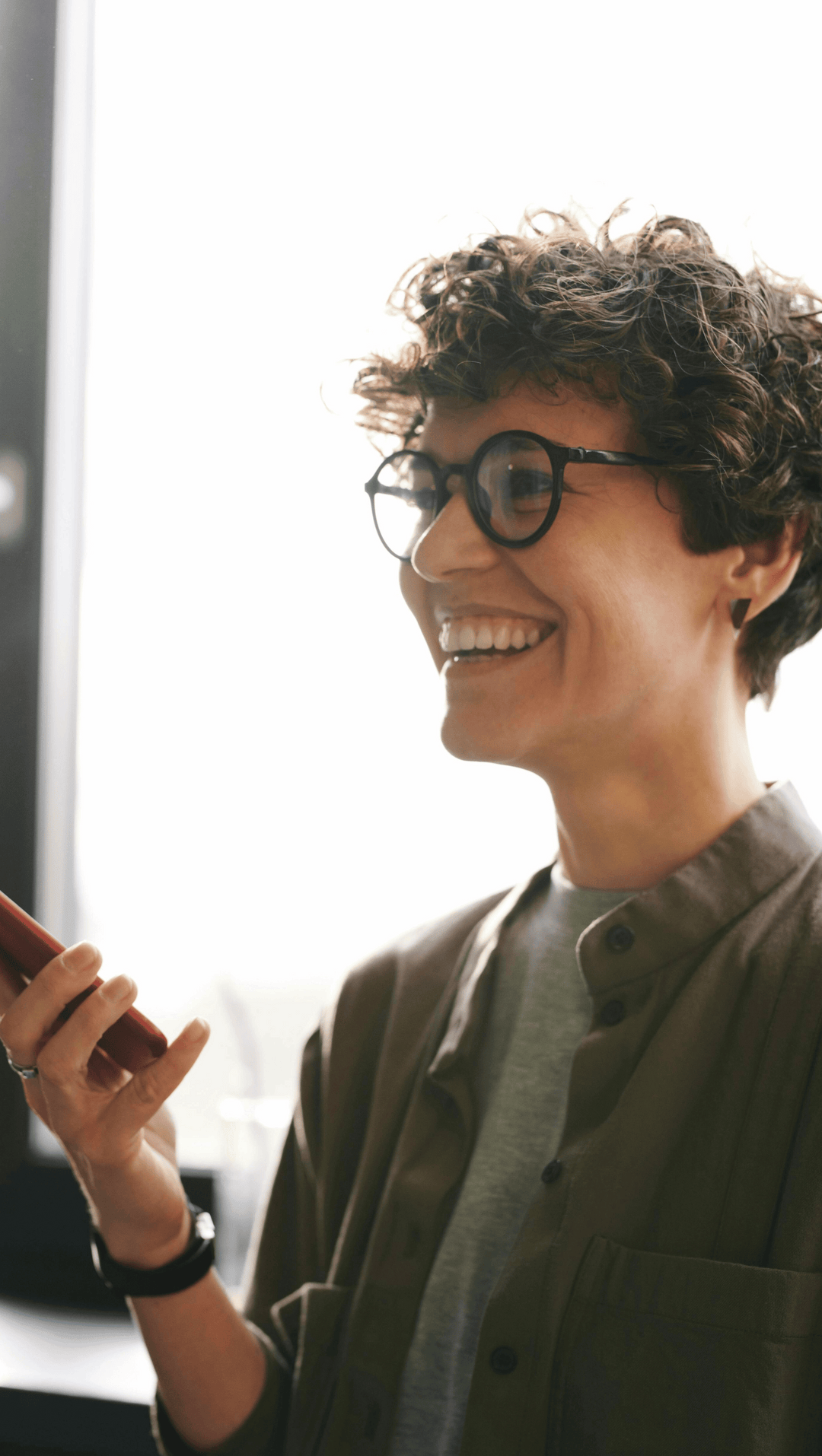 A woman smiling, happy to be part of her high performance organisation.